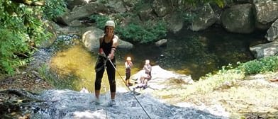 woman waterfall rappelling belize