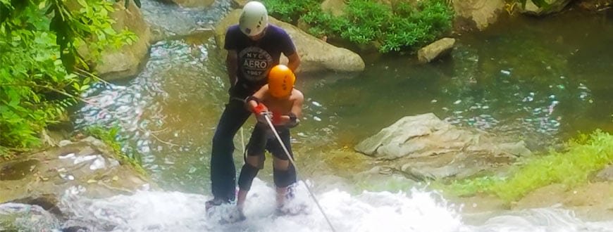 little boy waterfall rappelling in belize